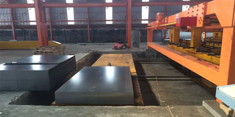 Stacks of cut steel sheets beside a cut-to-length line