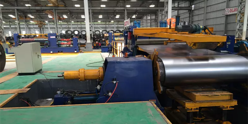 Large steel coil mounted at the recoiling section of a slitting line